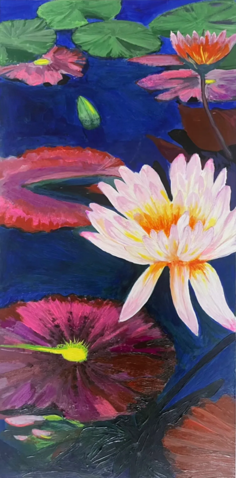 A fully opened white lotus rises from deep blue water among pink water lilies and green lily pads.
