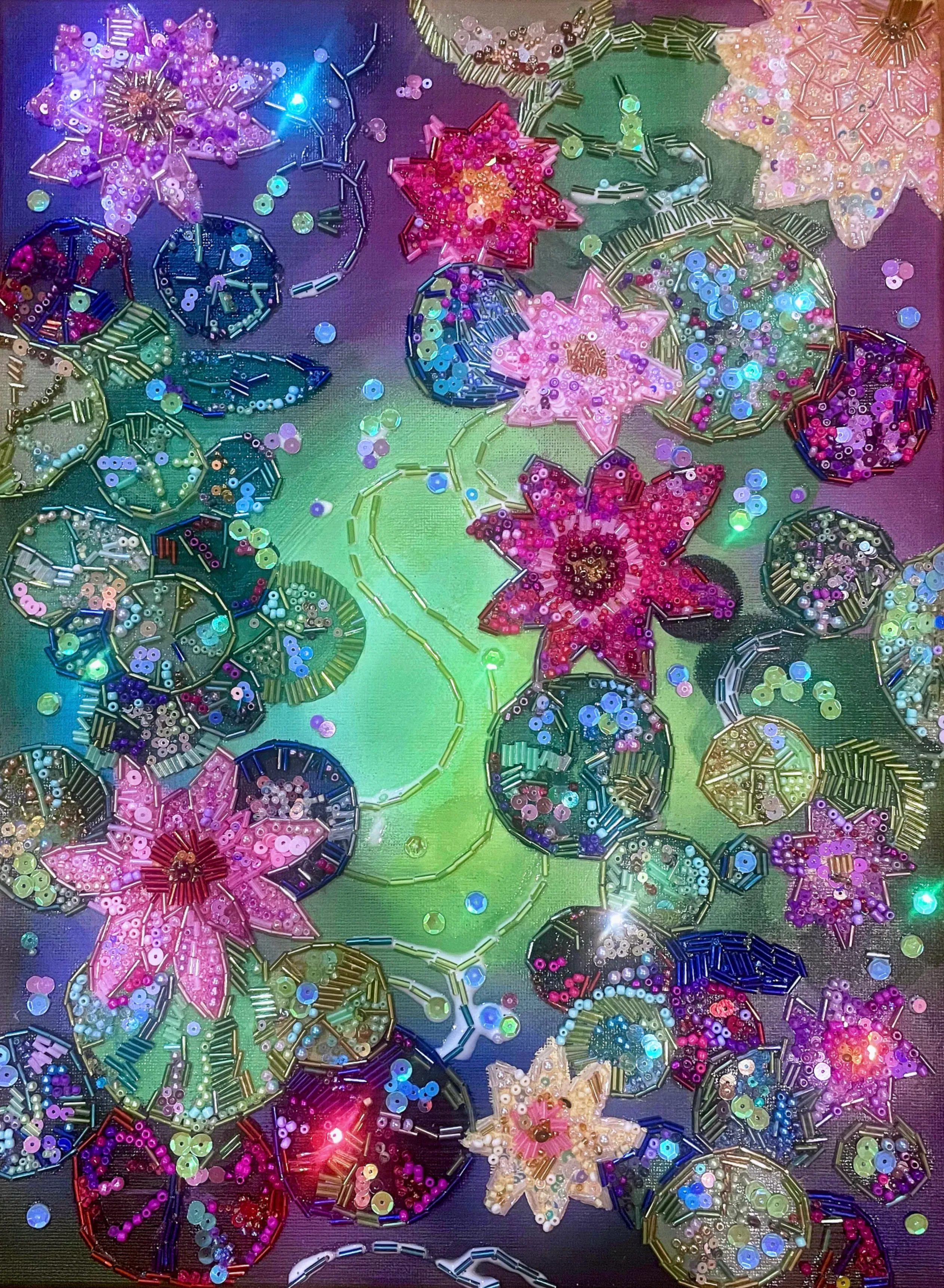 Bird’s-eye view of pink lotus flowers and green lily pads rendered in acrylic and beadwork.